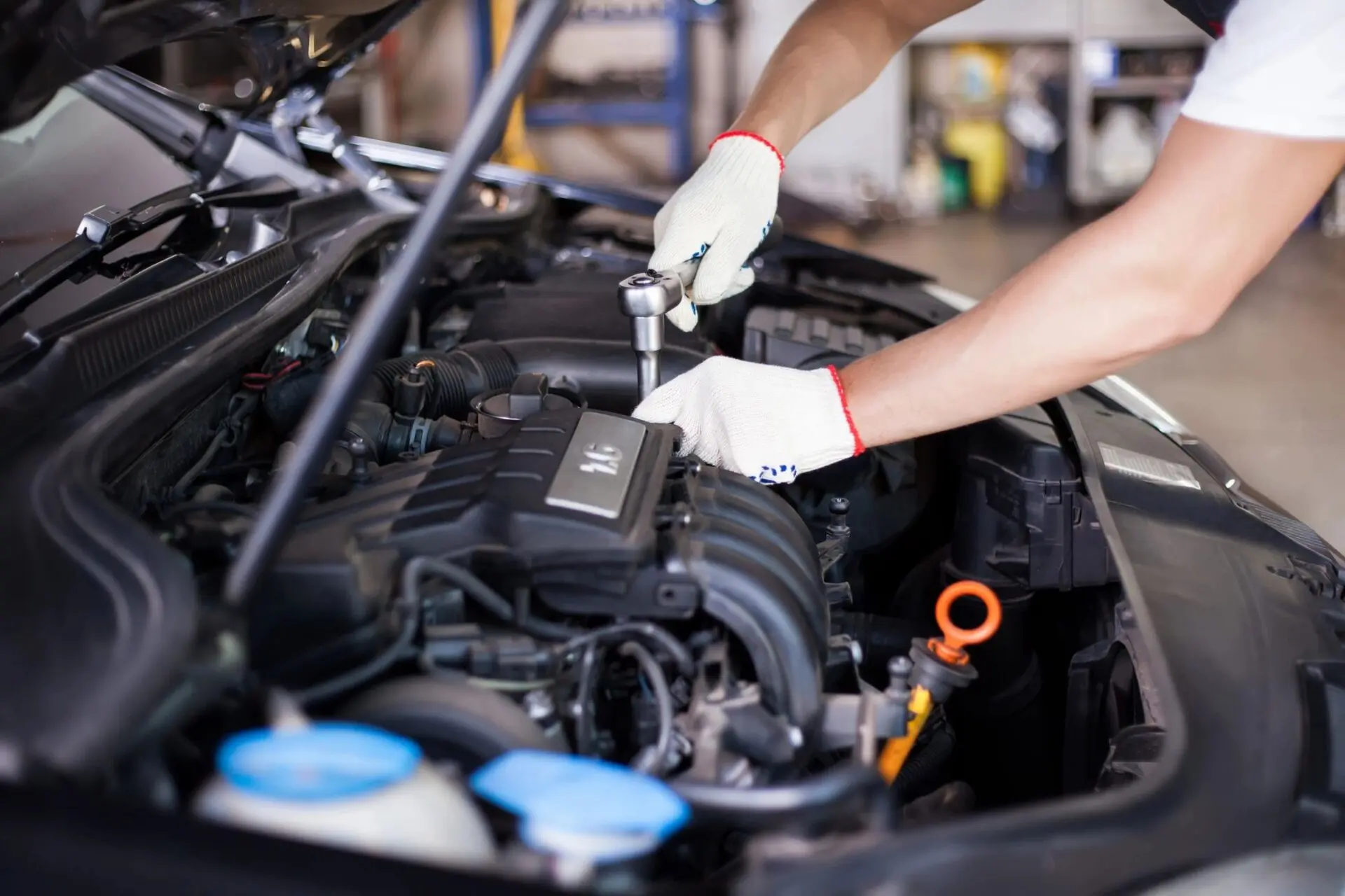 A person working on the engine of a car.